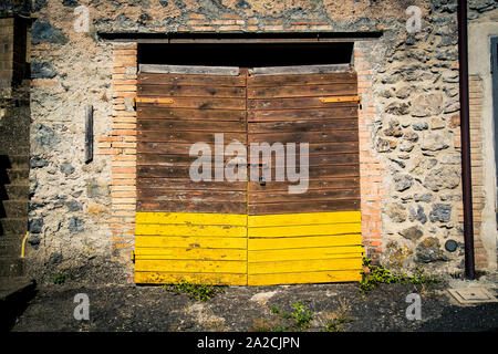 Ancient winery's door in Tuscany small town named Latera Stock Photo