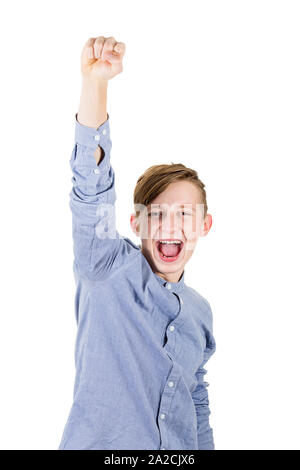 Excited boy teenager raising one hand up, holding fist and screaming as achieving success. Positive emotions celebrating victory as a winner isolated Stock Photo