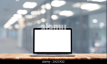Modern computer,laptop with blank screen on counter bar(retail store shop)and glass wall office backgrounds Stock Photo