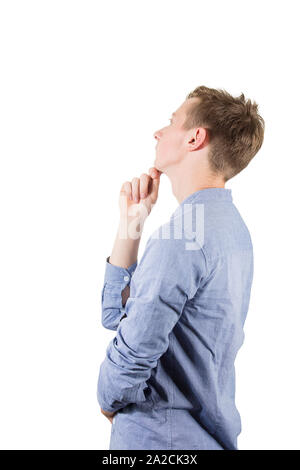 Side view of thoughtful student boy teenager keeps hand under chin looking aside isolated over white background. Adolescent guy thinking of an idea an Stock Photo