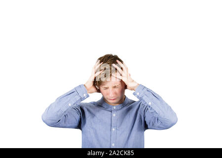 Distressed teenager boy mess in head, hands covering ears, eyes closed feeling pain, isolated over white background. Headache feeling , emotional stre Stock Photo