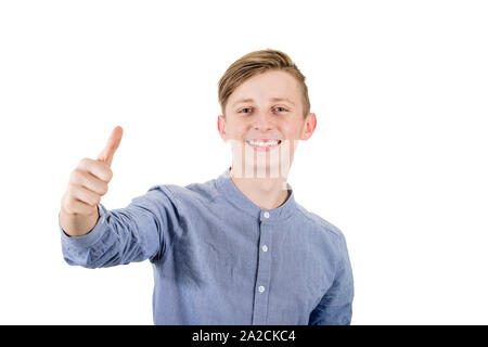 Cheerful boy adolescent showing thumb up positive gesture and excellent feedback, looking to camera teeth smile isolated on white background. Stock Photo