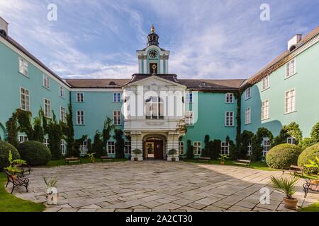 Dacice, Czech Republic - September 29 2019: View of square courtyard and green facade of a state-owned castle Dacice on a sunny day with blue sky. Stock Photo