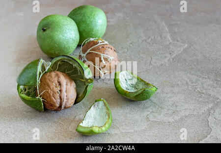 Walnuts in a green shell on the table Stock Photo