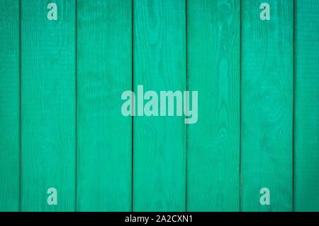 Wooden background texture. Creatively painted intense green boards. Stock Photo