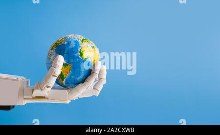 Robot holding Earth globe in hand, blue panorama background Stock Photo
