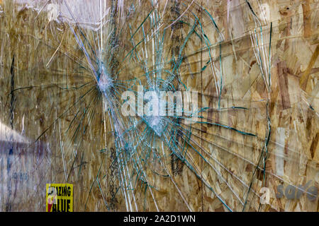 Broken shop window due to vandalism Stock Photo