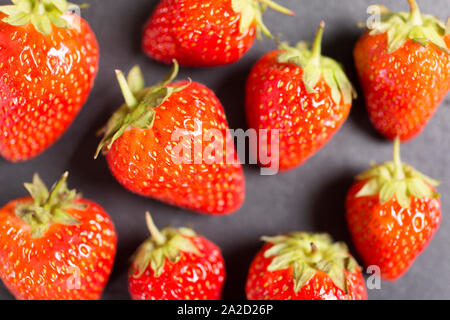 Fresh ripe strawberries on black slate Stock Photo