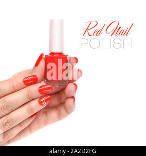 Hands of a woman with red manicure and nail polish bottle on white background Stock Photo