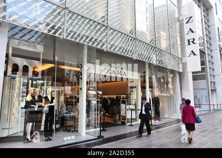 TOKYO, JAPAN - DECEMBER 1, 2016: People walk by Zara casual fashion store in Ginza district of Tokyo, Japan. Ginza is a legendary shopping area in Chu Stock Photo