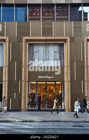 TOKYO, JAPAN - DECEMBER 1, 2016: People walk by Salvatore Ferragamo luxury fashion store in Ginza district of Tokyo, Japan. Ginza is a legendary shopp Stock Photo