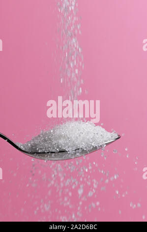 White Sugar Pouring From A Spoon Stock Photo