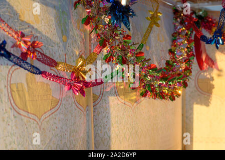 Colorful Sukkah decoration shiny garland at sunset light. Stock Photo