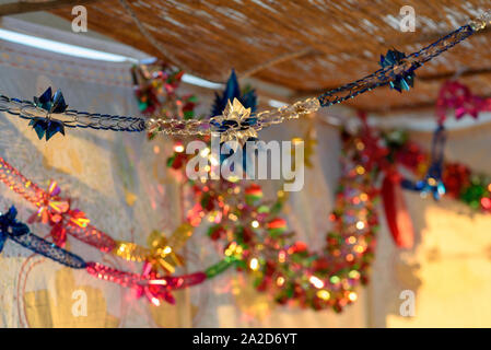 Colorful Sukkah decoration shiny garland at sunset light. Stock Photo