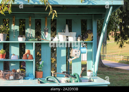 Teal Blue Garden Work Tool Bench with Flower Pots Stock Photo