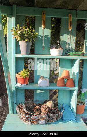 Teal Blue Garden Work Tool Bench with Flower Pots Stock Photo