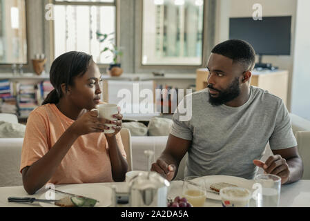 Young African American couple talking together an having breakfast Stock Photo