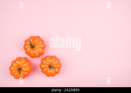 Pink background with three pumpkins. Stock Photo