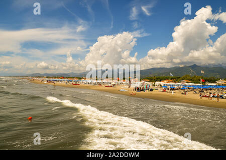 Scenic view of the sandy beach of Forte dei Marmi on the Tuscan coast with an awesome sky in a sunny summer day, Versilia, Tuscany, Italy Stock Photo