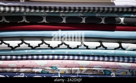 Fabrics in different patterns lined up in a row. Stock Photo