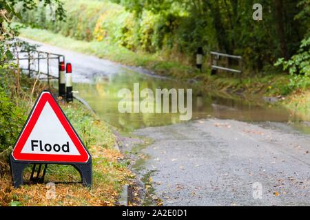 Flooded country road in England, UK with a flood road sign Stock Photo