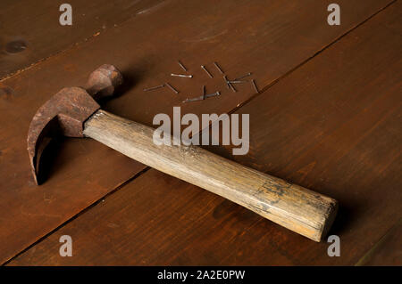Still life photography, old hammer, and nails on a wooden rustic table Stock Photo