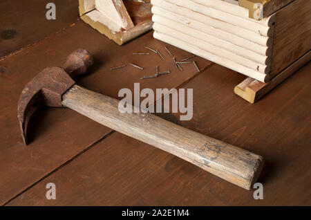 Still life photography, old hammer, and nails on a wooden rustic table Stock Photo