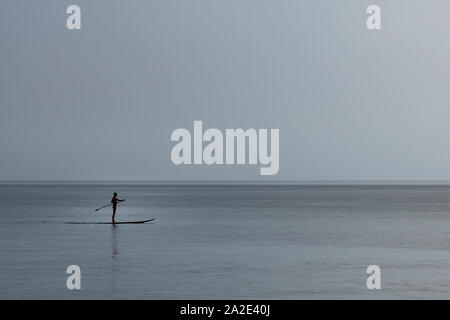 man paddling on sup in thailand Stock Photo