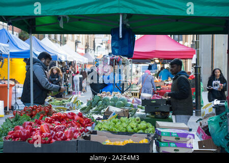 Vendor setting up stall at Croydon historic surrey street market Stock Photo