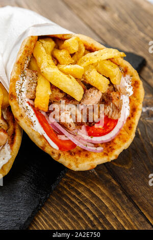 Traditional greek pork Souvlaki on balck plate and dark wood surface Stock Photo