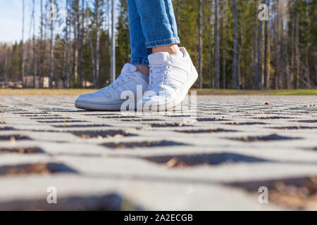 Girl stands on modern urban paving stones