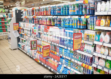 Minsk, Belarus - September 27, 2019: Counter with various toothpastes and brushes in a supermarket. Stock Photo