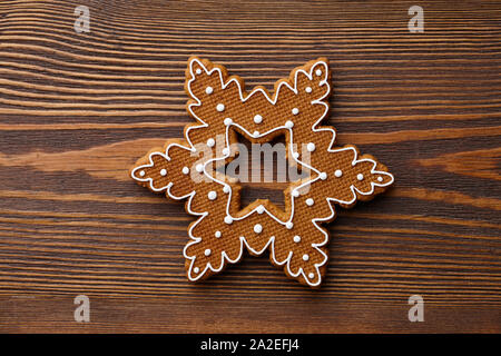 Christmas gingerbread snowflake on wooden texture Stock Photo