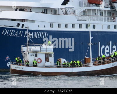 Close-up of a small boat alongside the larger passenger cruise ship, the Ocean Diamond, whilst cruising in Iceland, September 2019. Stock Photo