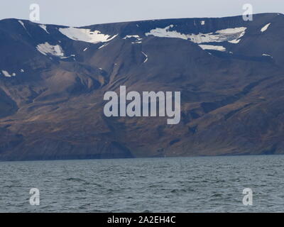 Icelandic scenery of choppy waves and distant mountains with glimpses of ice, Skjalfandi Bay Stock Photo