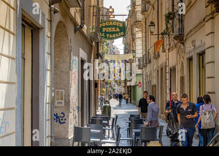 People walking down  Via Porta Palatina a narrow street in Turin ,Italy Stock Photo