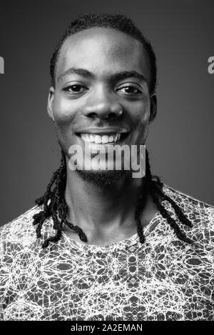 Young handsome African man against brown background Stock Photo