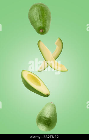 Sliced Avocado isolated in green surface viewed from above Stock Photo