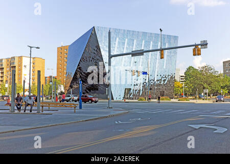 Two guys sit on a bench on Euclid Avenue across from the Cleveland Museum of Contemporary Art in the University Circle district of Cleveland, Ohio, US Stock Photo