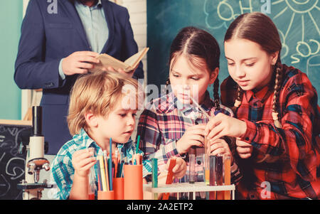 Inspired to work hard. happy children teacher. doing experiments with liquids in chemistry lab. chemistry lab. back to school. Stock Photo