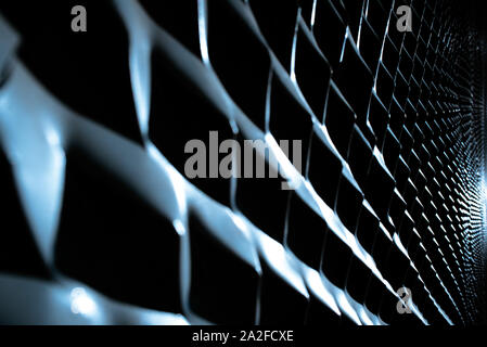 Industrial background of diagonal metallic protrusions illuminated with strong light and intense shadows. Stock Photo