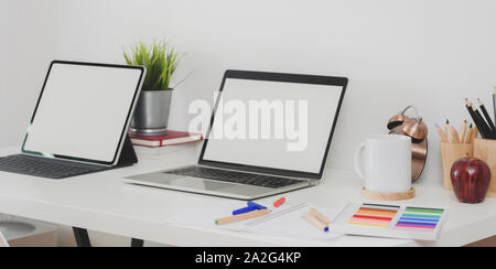 Back to school concept : Blank screen laptop computer and tablet with stationary and decorations on modern workplace Stock Photo