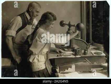 Embossing shop of Harry C. Taylor, 61 Court Street. 15-year old girl at embossing machine. Stock Photo