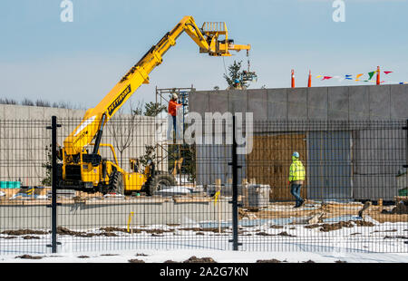 Grand Rapids Michigan, March 8, 2019; a construction crew is seen working construction on an addition to a building Stock Photo