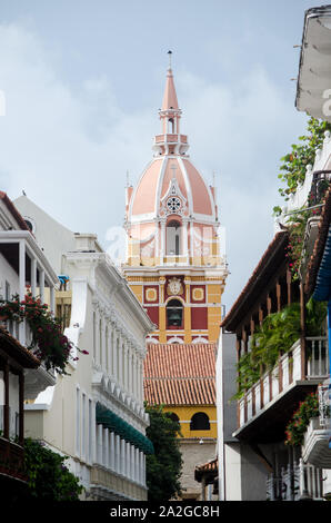 Cathedral of St. Catherine of Alexandria appears in the horizont between the colonial balconies of Cartagena Stock Photo