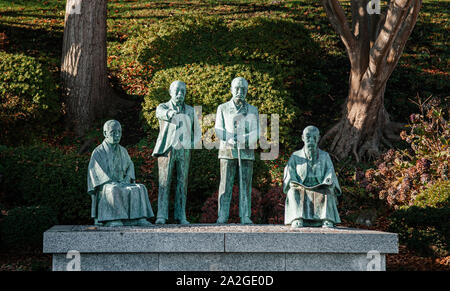 DEC 2, 2018 Hakodate, JAPAN -Bronze statue of four great Hakodate city founder monument at Motomachi park - Old Public Hall Stock Photo