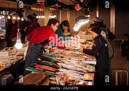 DEC 2, 2018 Hakodate, Japan - Japanese seafood shops with sellers and buyers at Hakodate Asaichi fish market Hokkaido. Famous fresh seafood and street Stock Photo