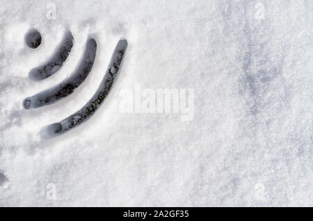 Wi Fi sign drawn in the snow on a sunny day Stock Photo