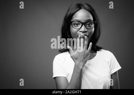 Photo of a beautiful young african shocked emotional woman posing ...