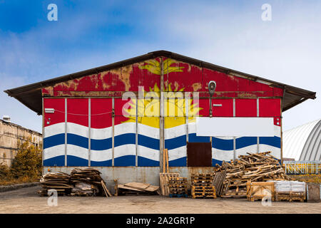 Close-up of the national flag of Kiribati  painted on the metal wall of a large warehouse the closed territory on a summer day. The concept of storage Stock Photo